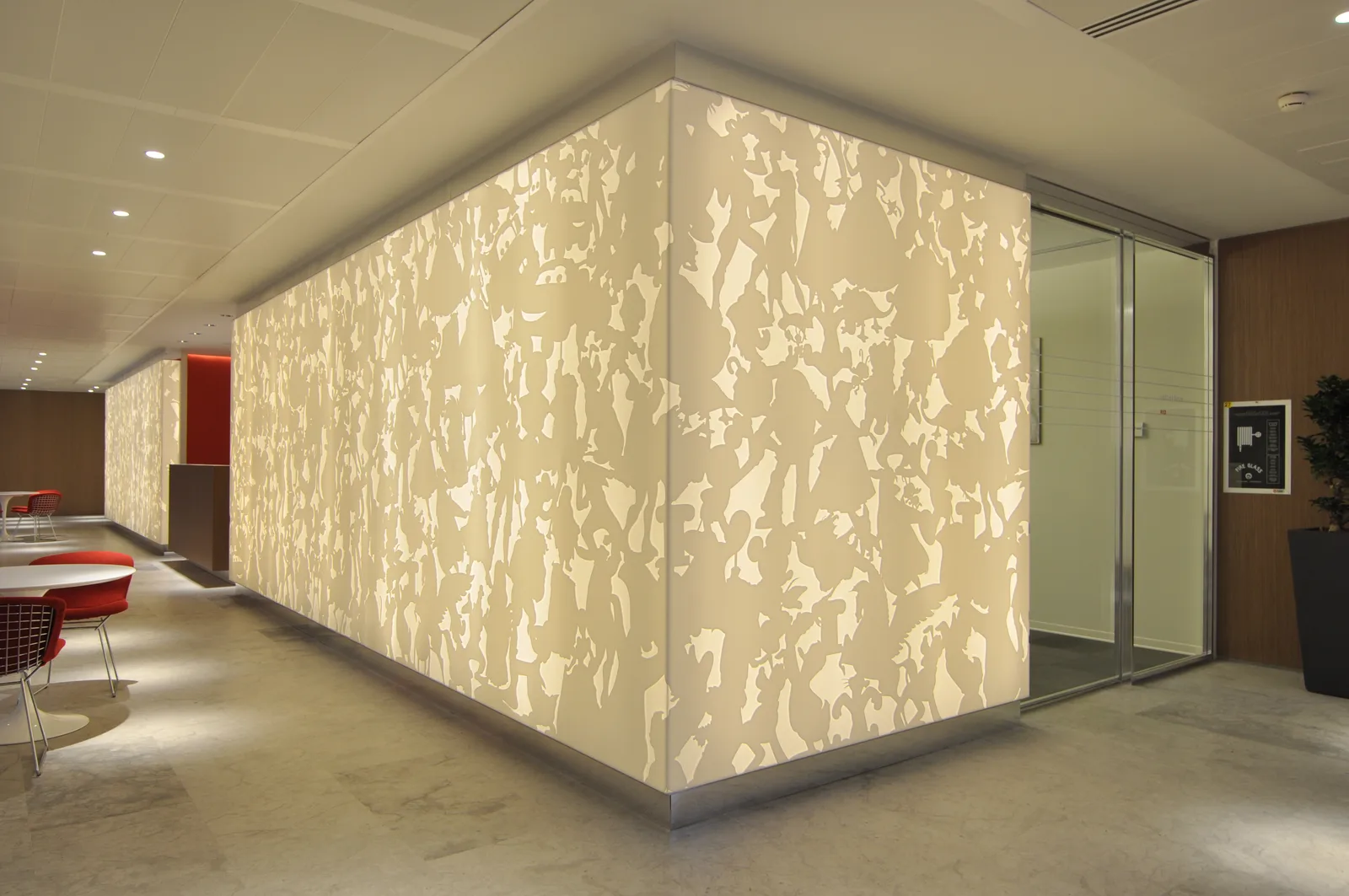 Corian panel corner detail showing how the architectural box wraps the corner, with laser-cut Disney pattern at human scale