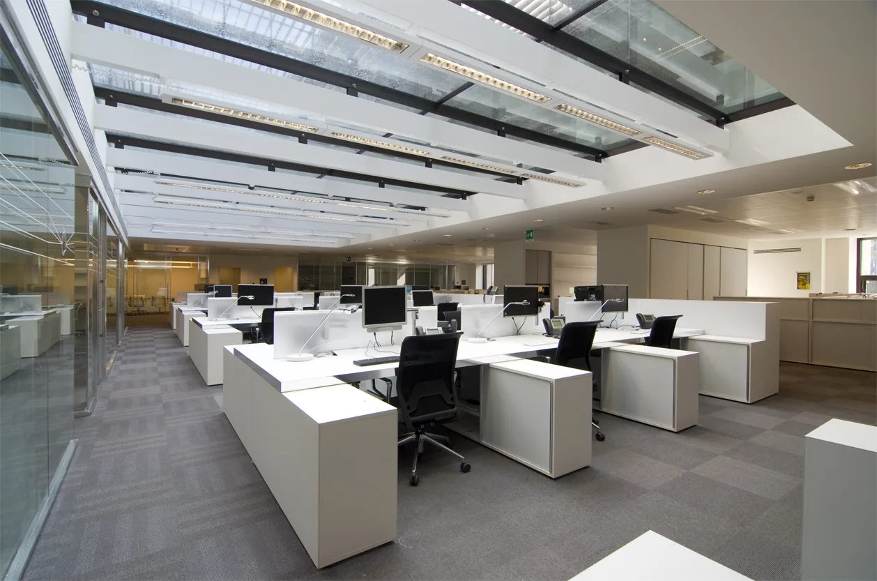 Ground floor lobby interior with the LED-backlit Corian panels casting patterned light across the floor