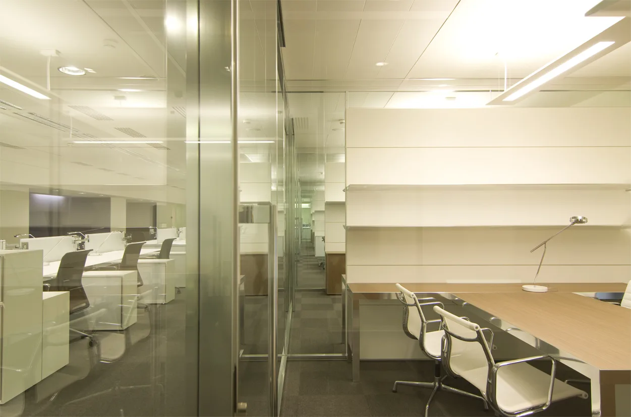 Level 1 meeting area with colour accent furniture and the consistent white lacquer material language