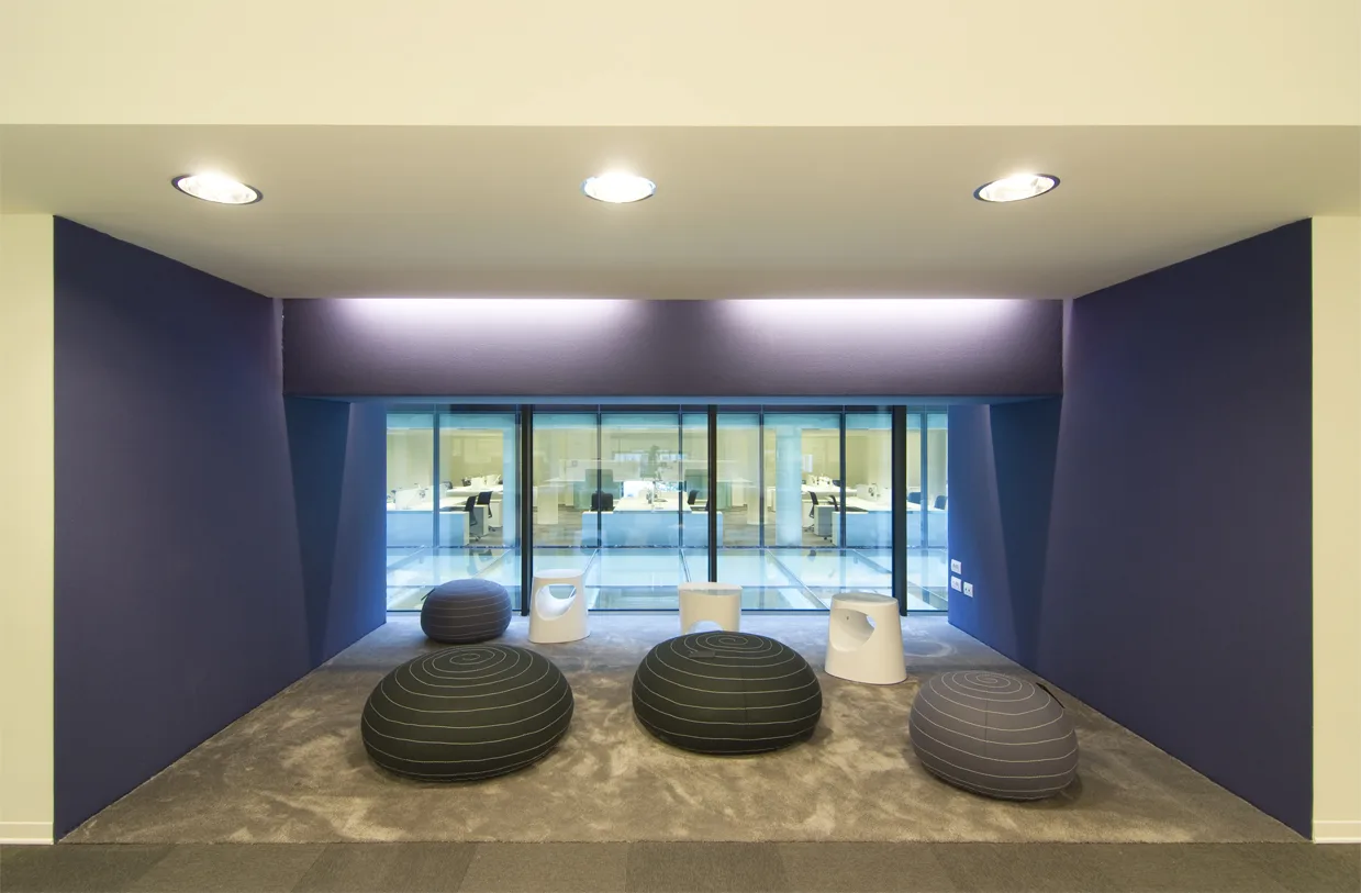 Level 1 open workspace panoramic view with the purple floor identity visible across furniture and walls