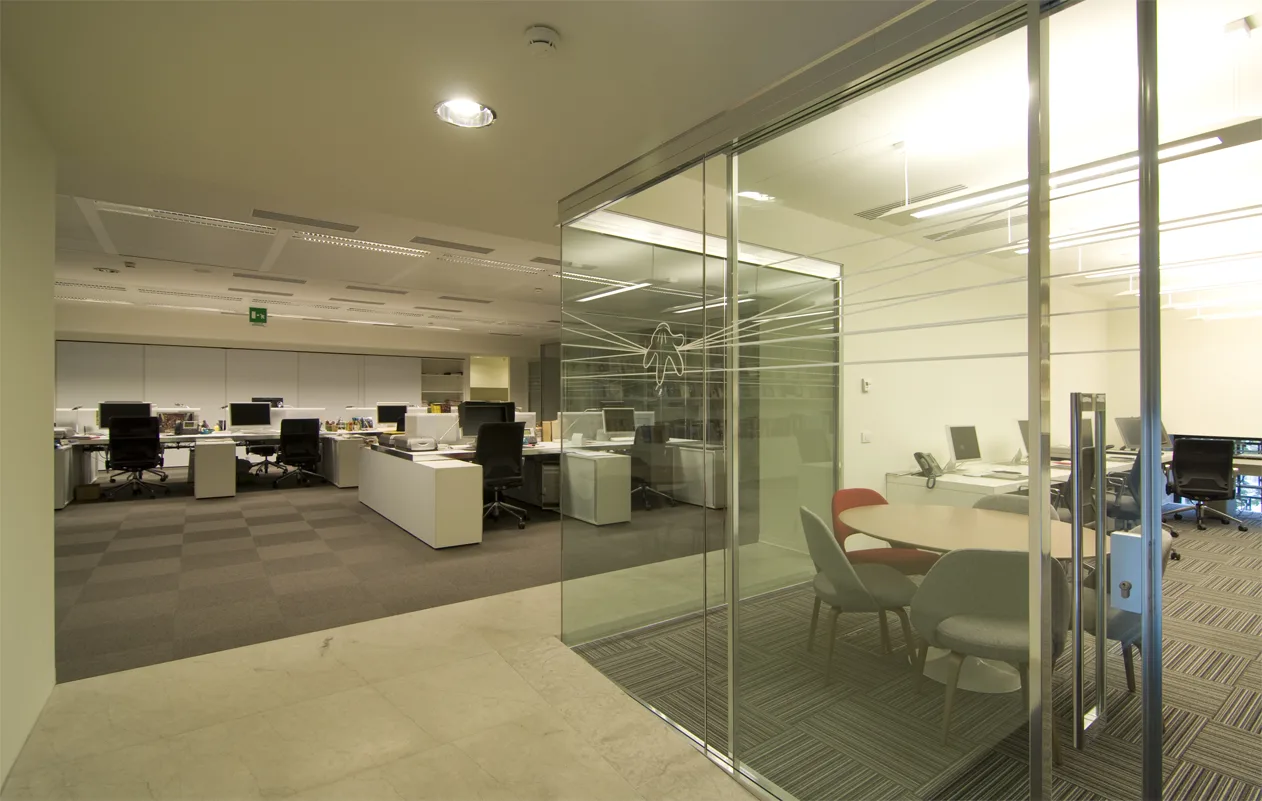 Level 1 corridor and transition space with glass partitions and environmental graphics