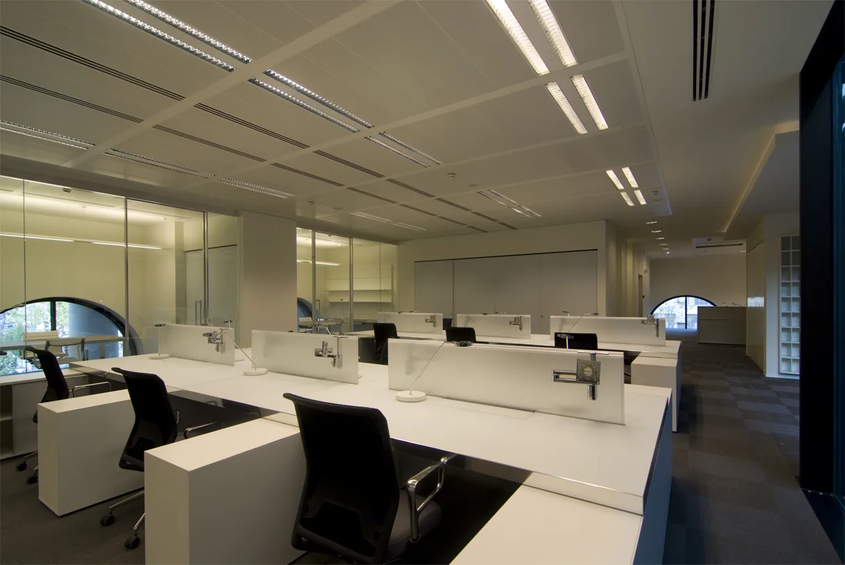 Level 2 corridor view through glass partitions showing the heritage structure and modern workspace