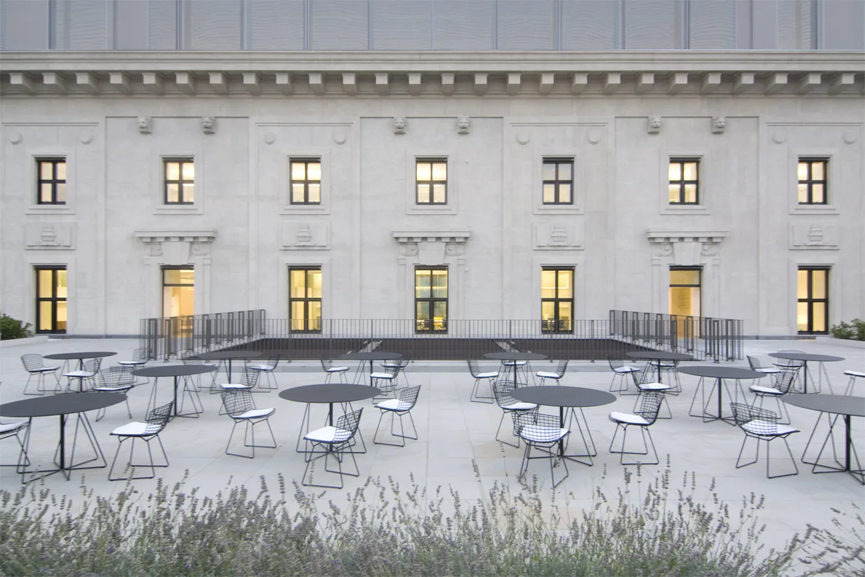 Terrace seating area with views over the palazzo courtyard and upper-level office windows