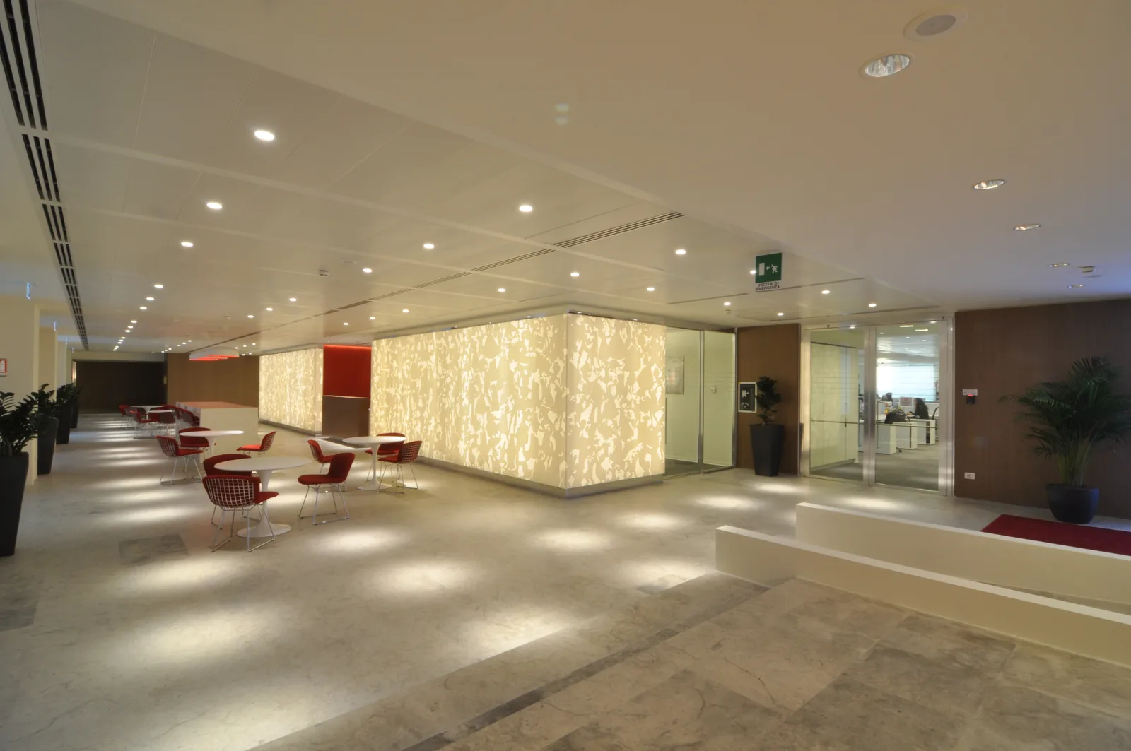 Widest ground floor overview showing reception, bar, and gallery zones in a single frame with Perle stone flooring throughout