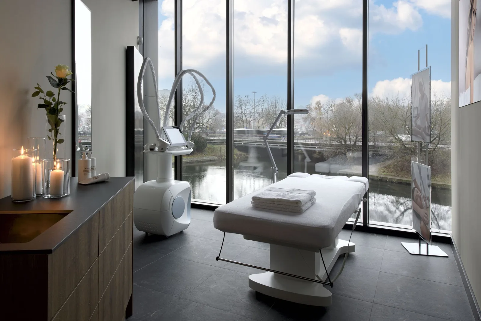 Exterior: ground floor view of Dr Irena Eris beauty salon showing curtain-wall facade, interior visible through glazing, and Nordic Haven tower context