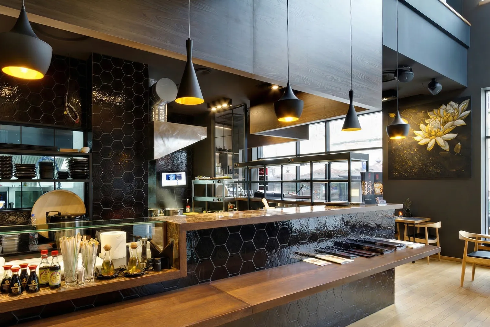 Interior: ground floor sushi bar with black hexagonal tiles, Tom Dixon Beat pendants, open kitchen, and golden lotus artwork