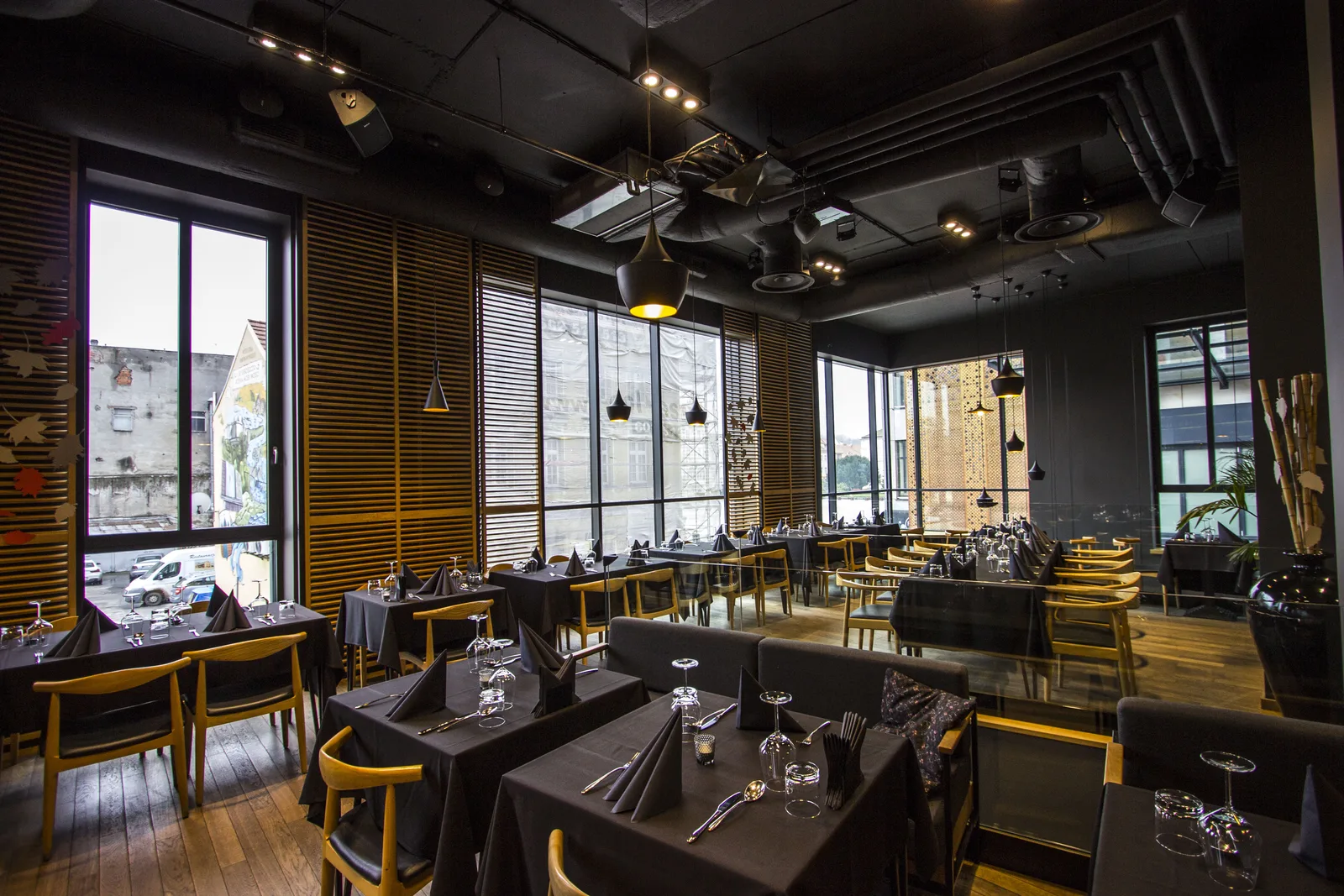 Interior: upper floor dining with venetian blinds, Tom Dixon pendants, dark tablecloths, oak chairs, and window views to Old Market Square