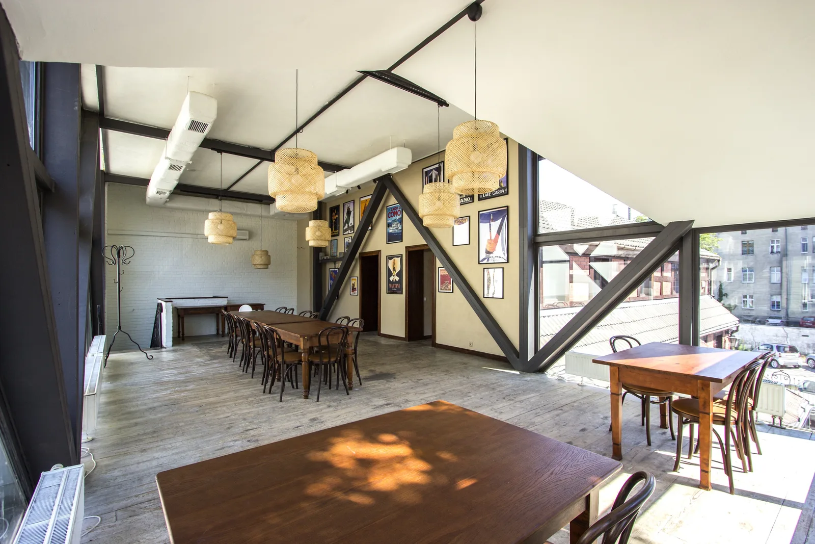 First floor wide panoramic view with Sinnerlig rattan pendants showing full spatial depth, triangular windows, and whitewashed brick walls