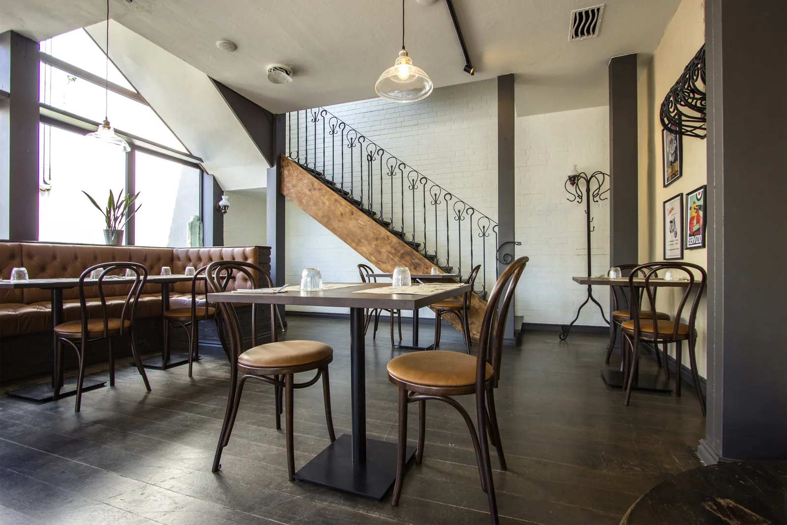 Ground floor bar area from the dining room side showing the subway tile counter, track lighting, and warm timber atmosphere