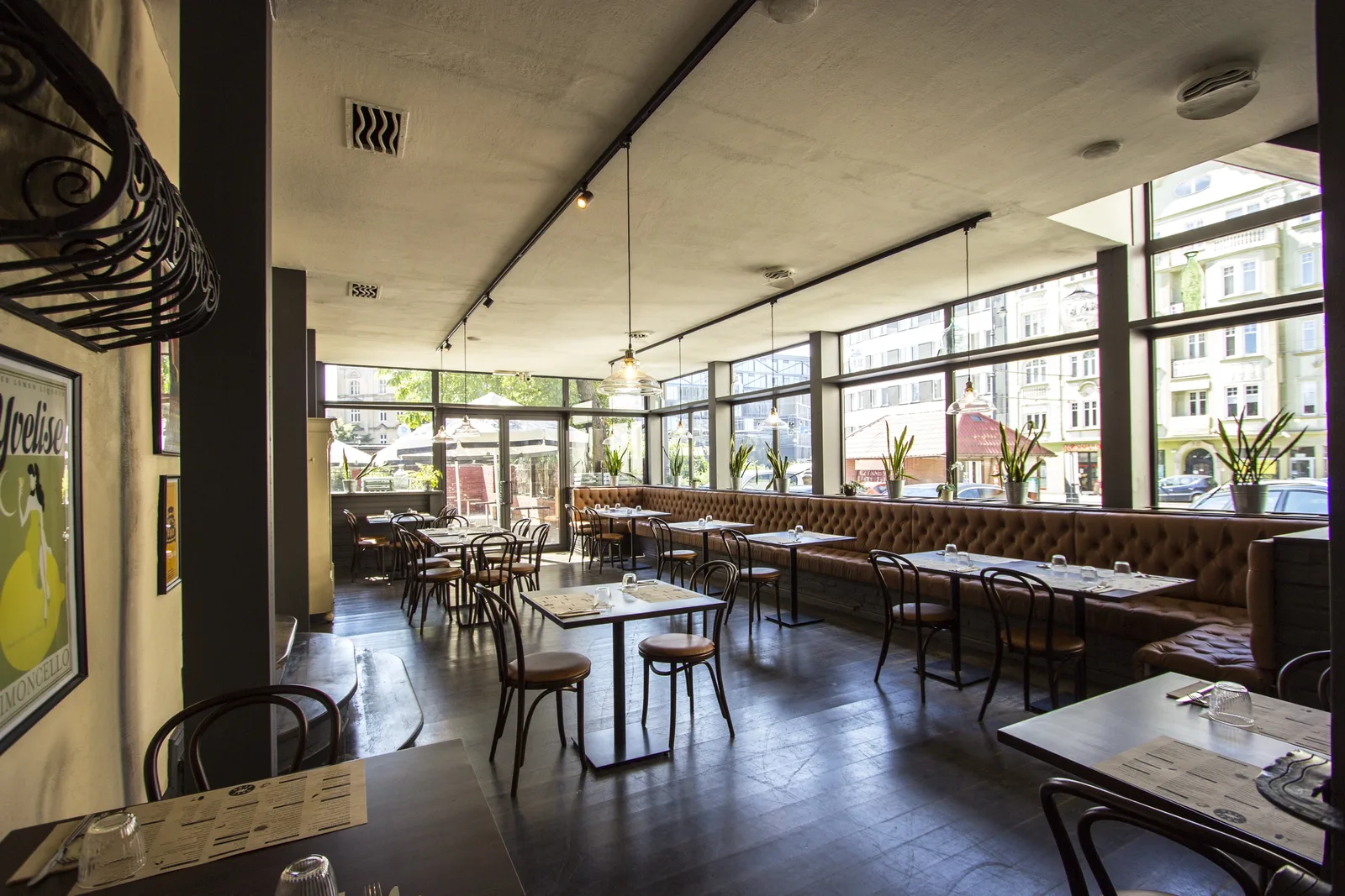 First floor secondary dining room with white brick walls, steel structural elements, and angular windows casting geometric shadows
