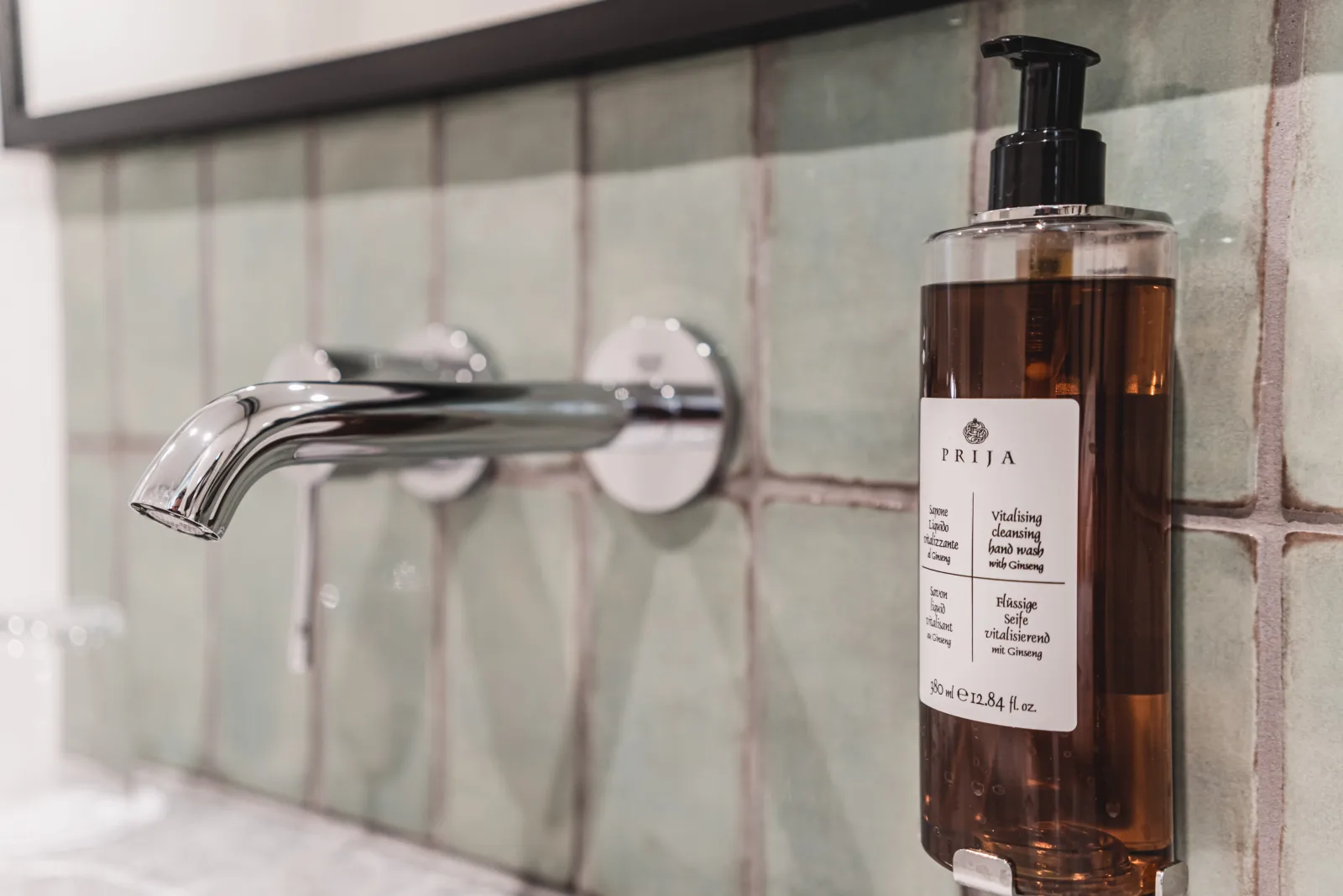 Wall-mounted faucet with soap dispenser, zellige tile background