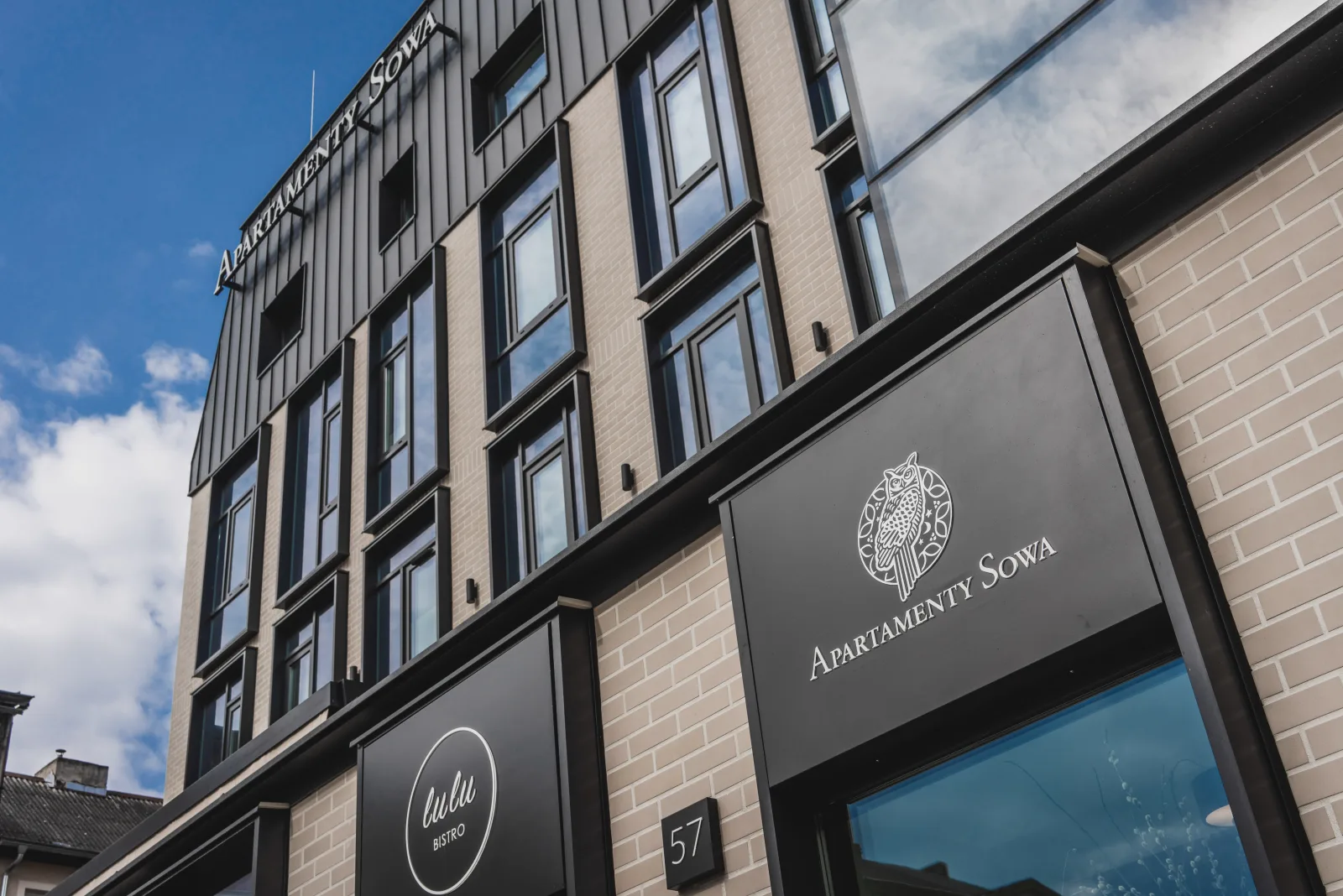 Apartamenty Sowa branded signage on building facade