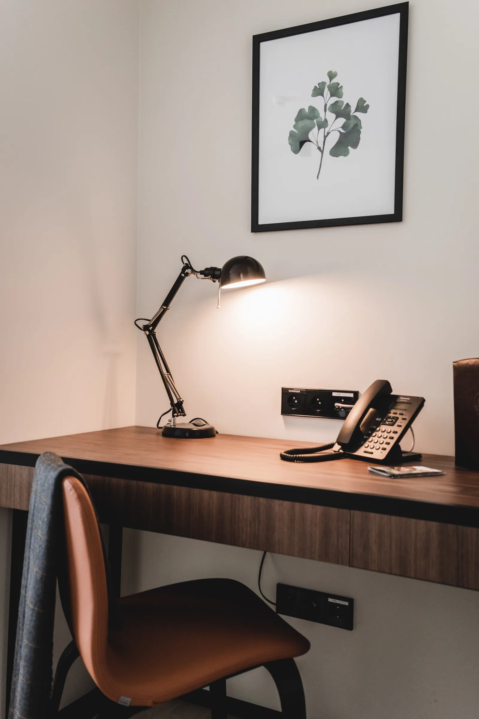 Desk with task lamp and telephone, walnut paneling