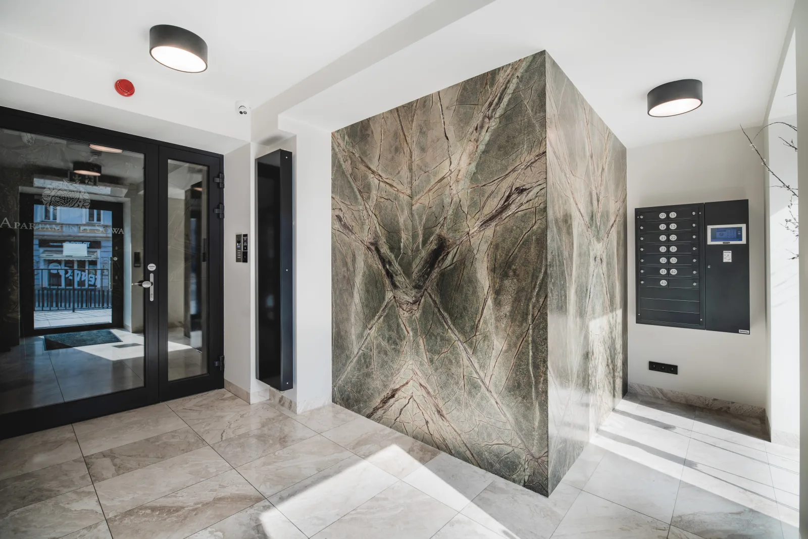 Interior lobby with marble walls and elevator panel