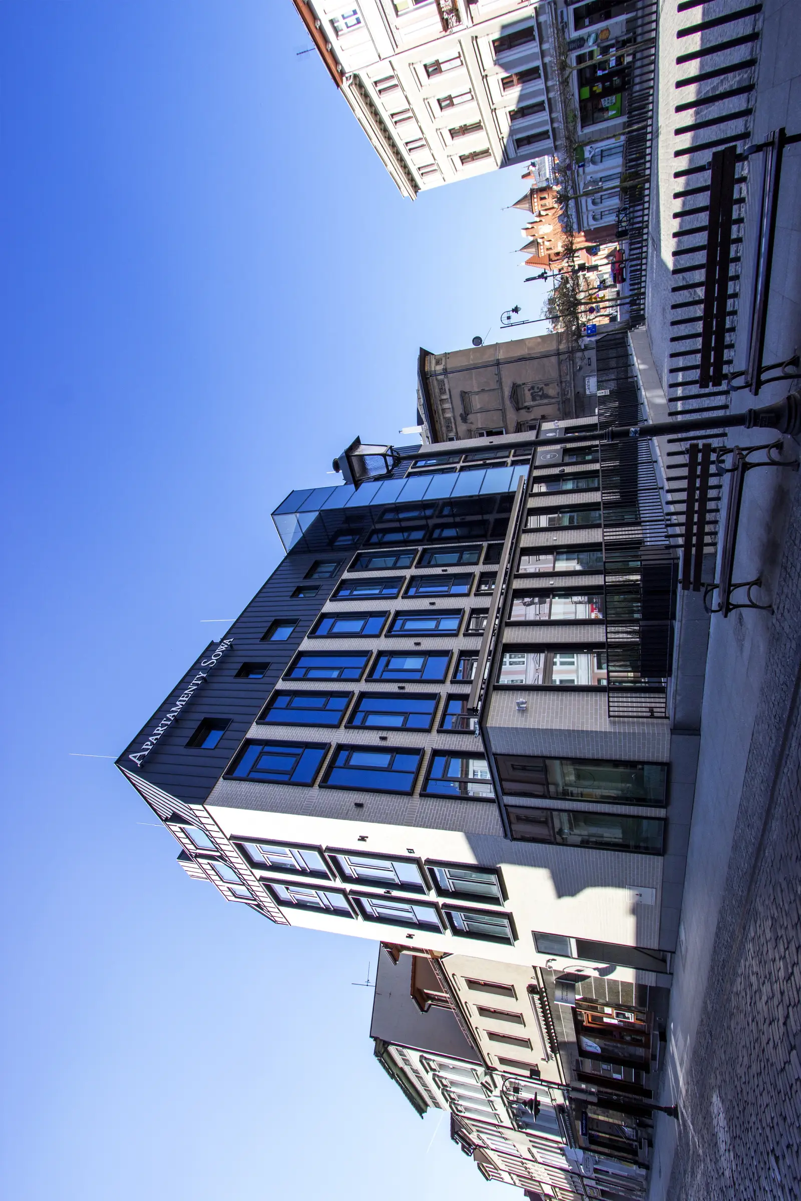 Front facade with Apartamenty Sowa branded signage at street level