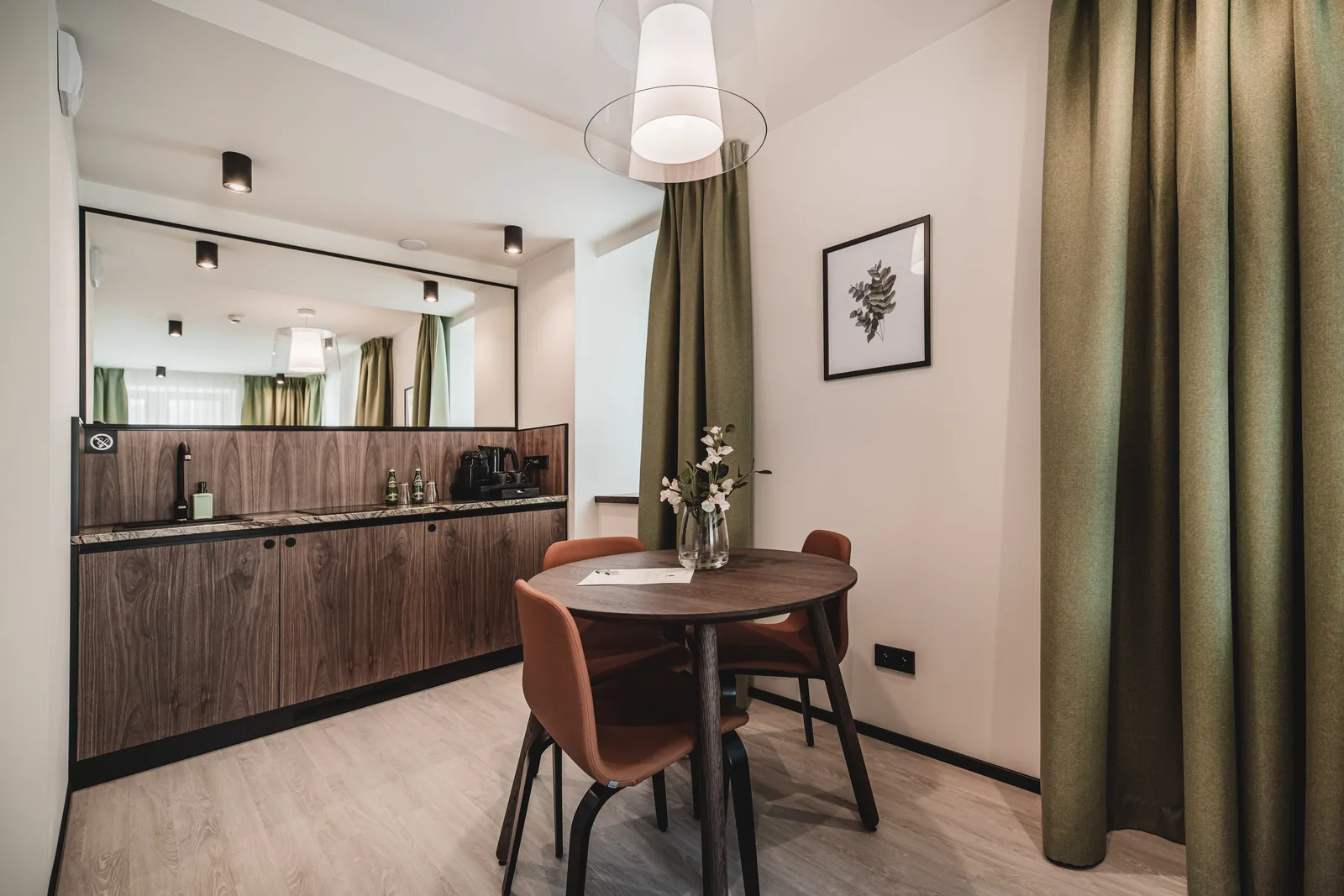 Apartment living and dining area with green curtains