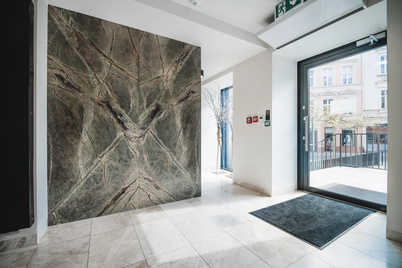 Entrance vestibule with dramatic rainforest marble feature wall
