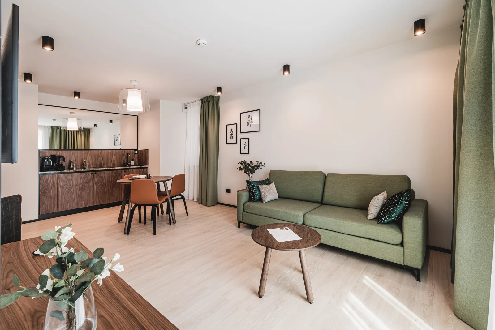 Apartment living room with leather armchair, walnut finishes