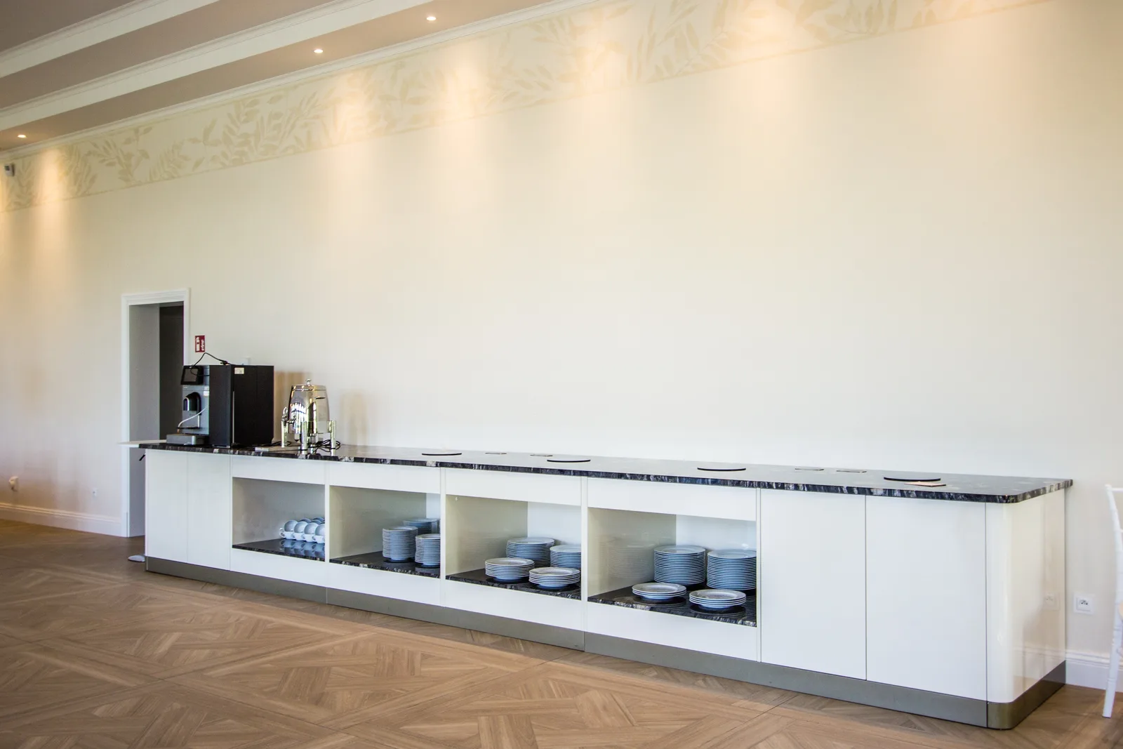 Orangerie bar detail showing glass rack and material palette