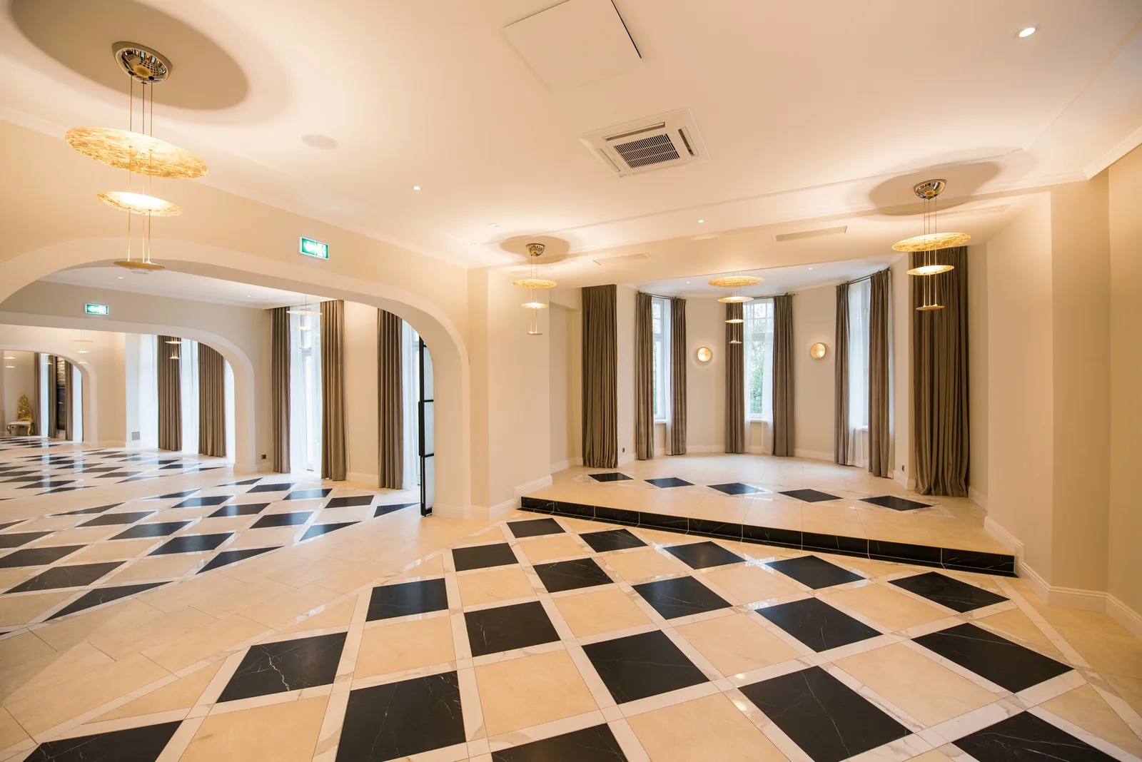 Stage and dance floor area with columns, pendants, and raised performance platform