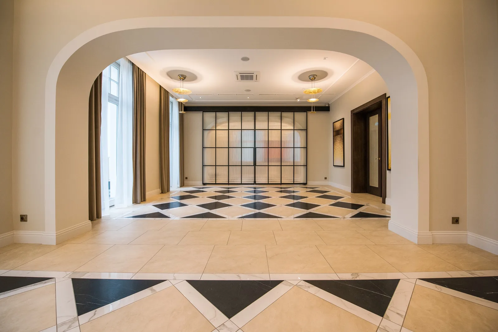 Corridor view through heritage arches toward distant rooms