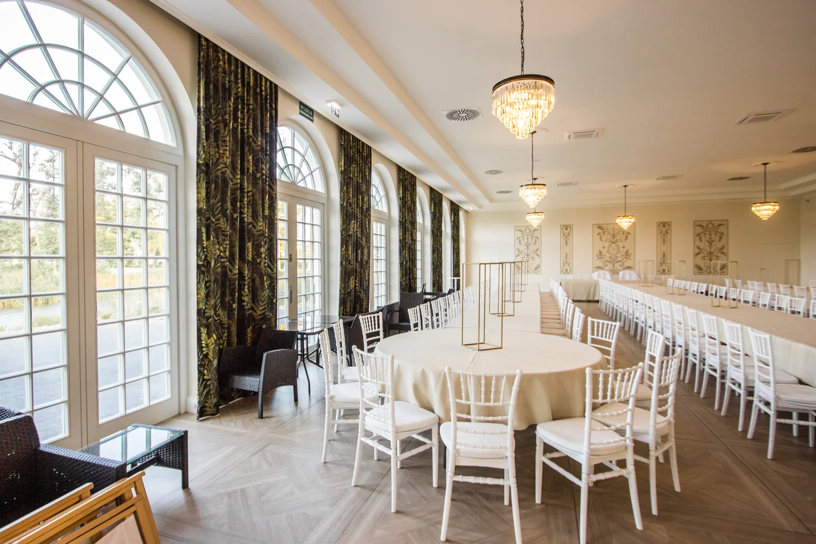 Orangerie interior showing chandelier lighting and window patterns