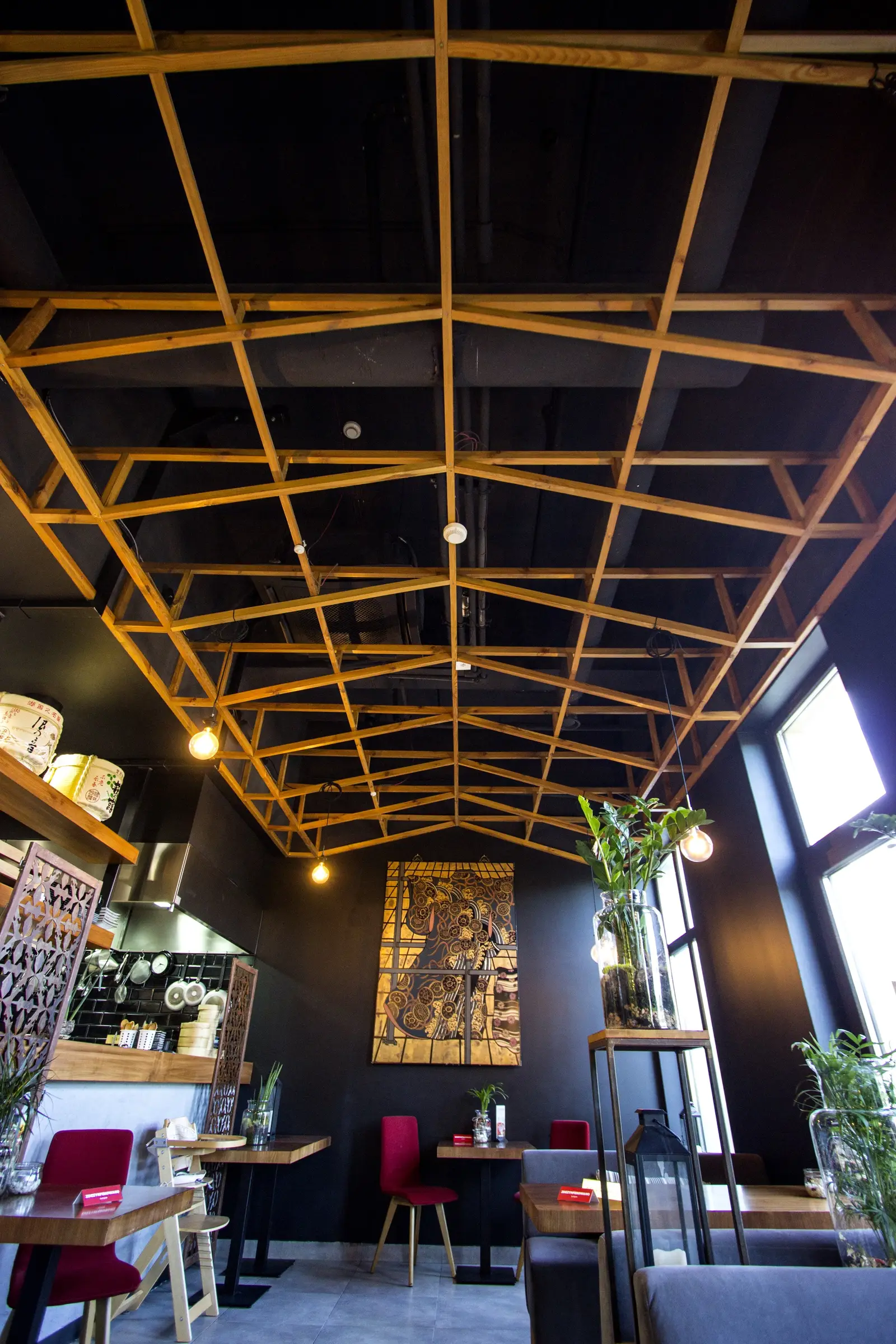 Interior: upper floors — wooden lattice and pendants from below, dining hall depth visible