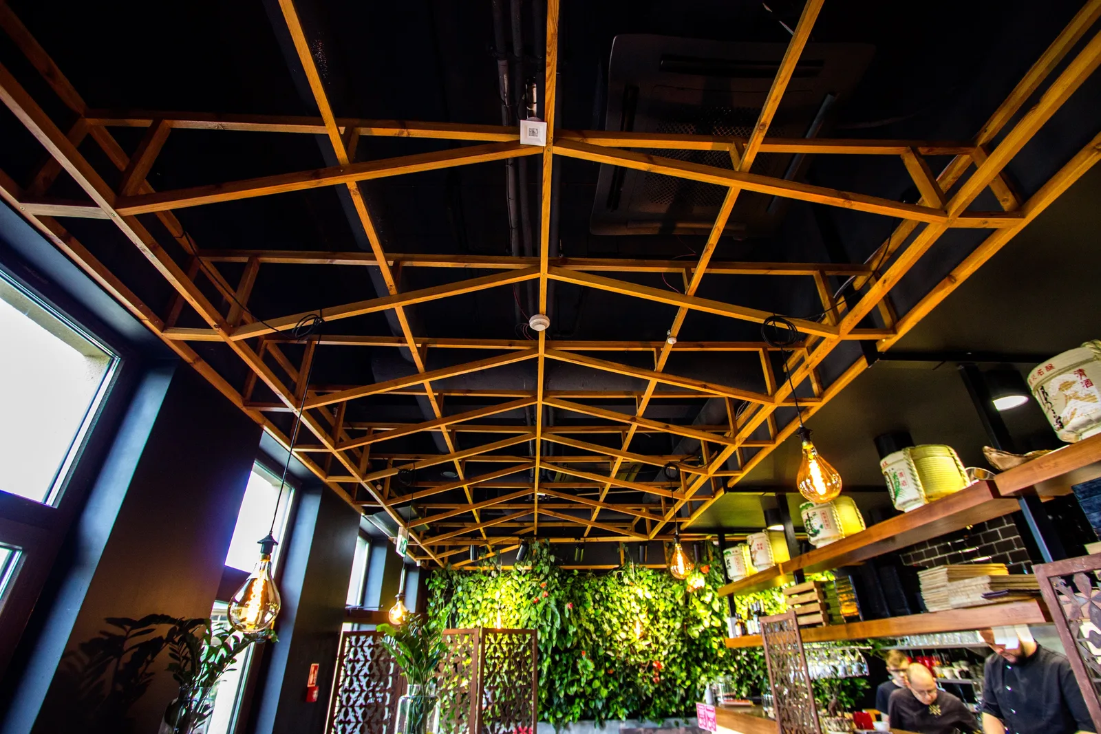 Interior: ceiling lattice from below — overhead structural timber grid, pendant lights