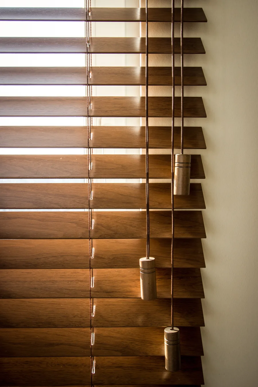 Living room shelf detail with books, decorative objects, and black laminate media wall framing