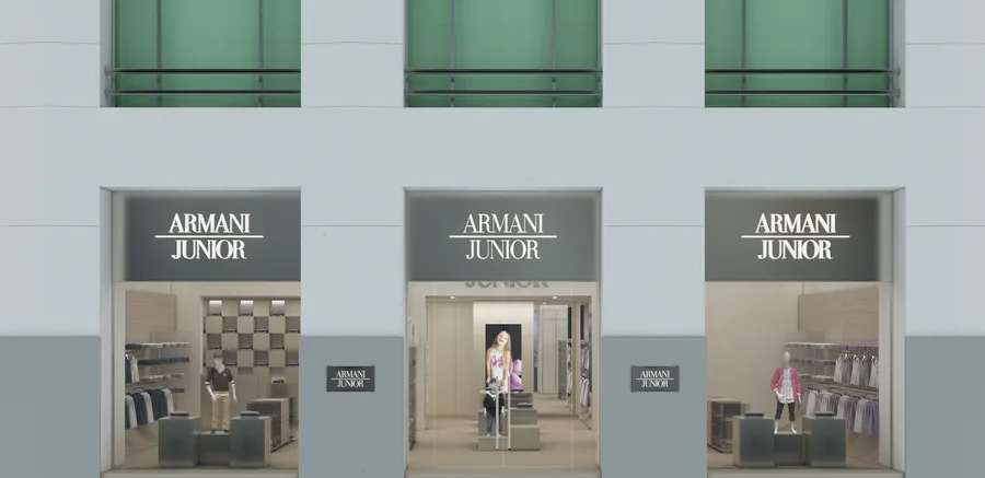 Interior: Barcelona store depth view showing L-shaped floor plan extending into Modernista building with boys and girls merchandise zones and beam lighting