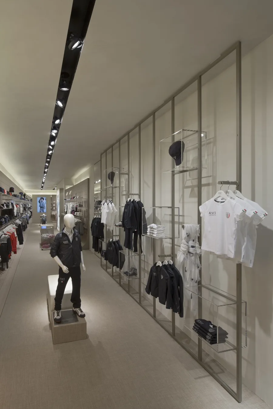 Interior: Doha mall entrance format Armani Junior store with flanking campaign lightboxes reflecting Middle Eastern retail typology in shopping centre