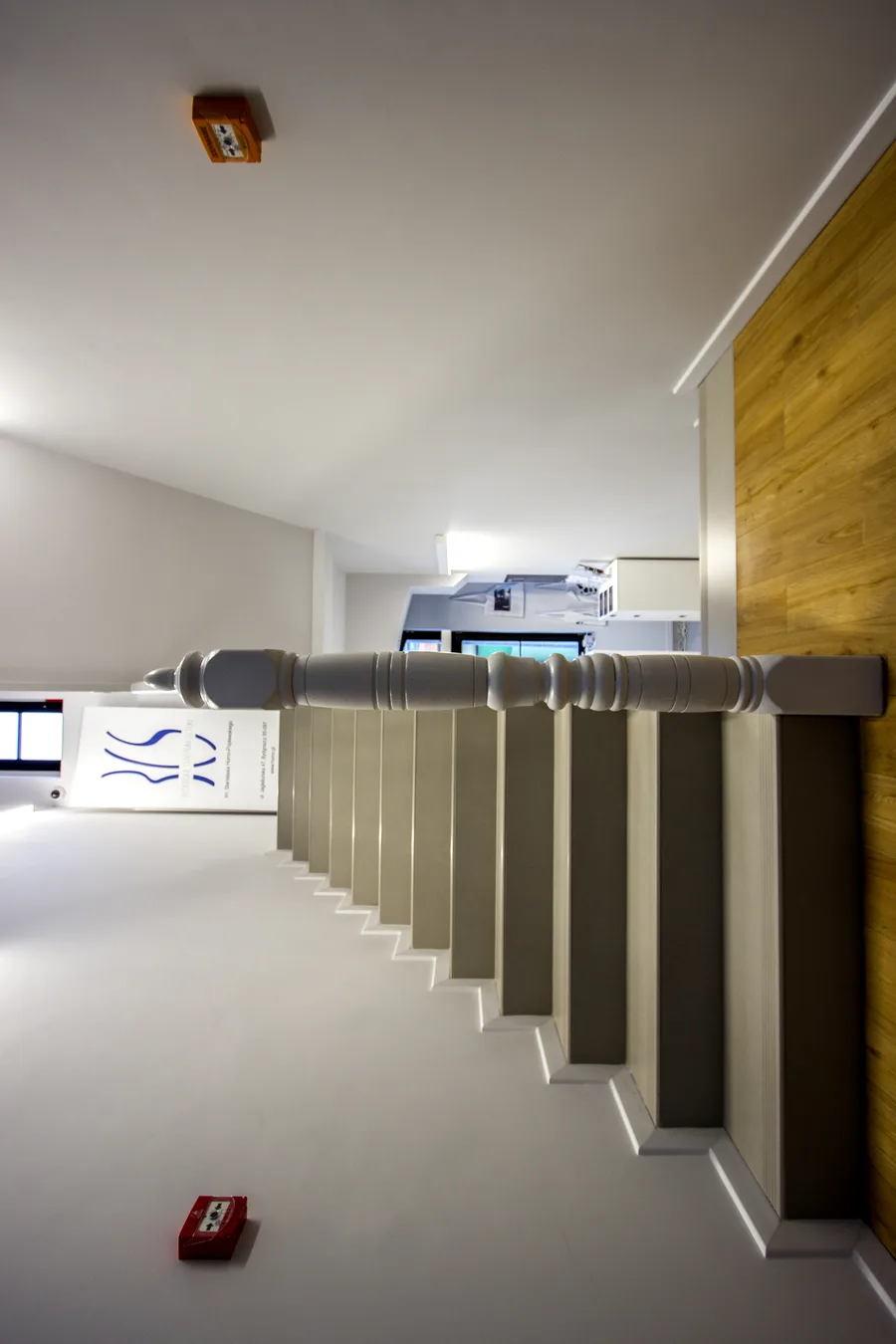 Interior: staircase detail demonstrating the dialogue between heritage industrial brick and timber structure and contemporary minimalist white drywall intervention with metal railings