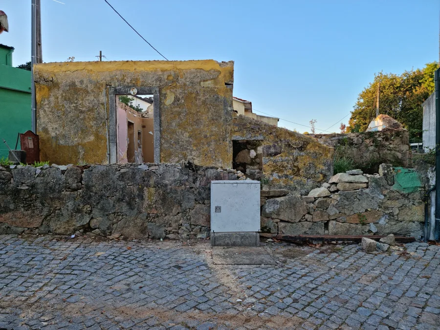 Construction: interior stripped walls photo showing building archaeology with multiple paint and plaster layers on rough-hewn granite masonry exposed during demolition revealing construction history