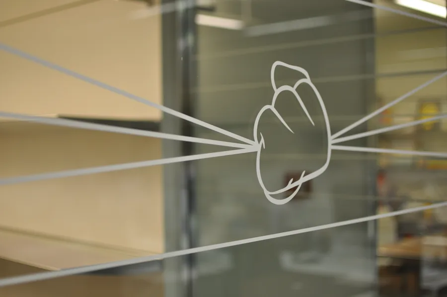 Close-up of 45 Gradi etched glass environmental graphic showing an abstracted Mickey glove motif, the D&AD-awarded design element