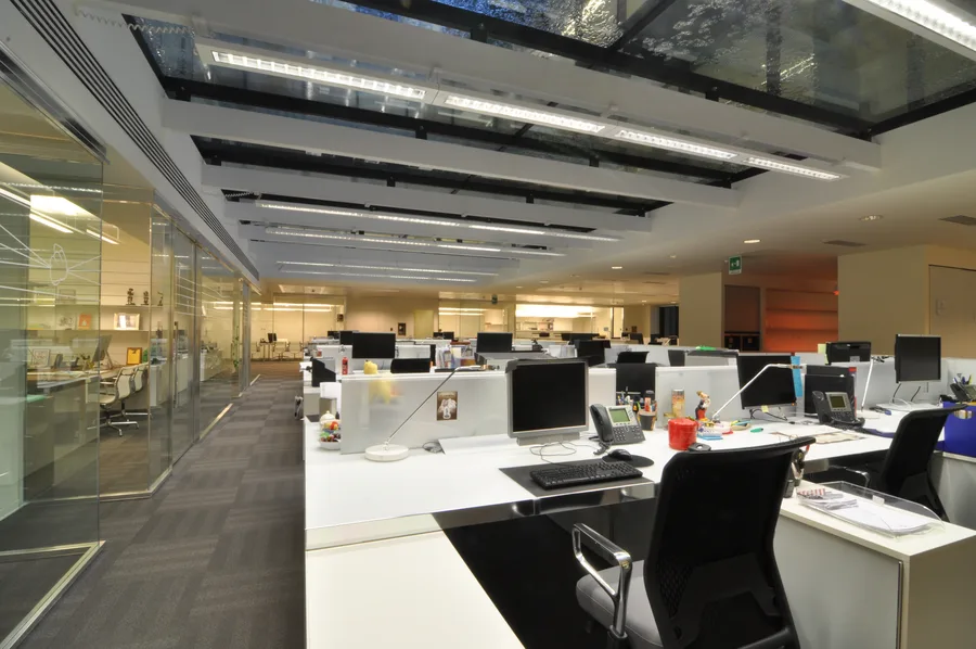 Ground floor interior detail capturing the spatial depth between Corian panels and reception desk