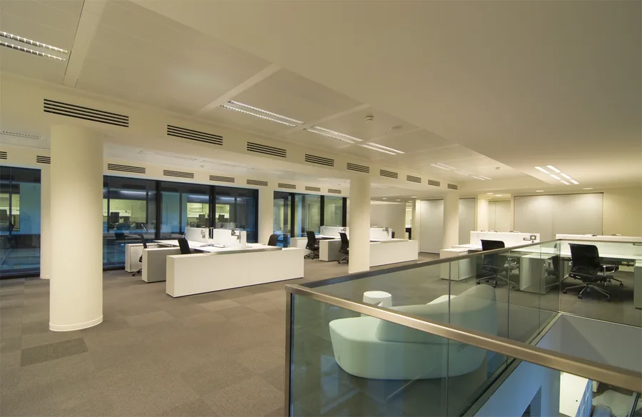 Level 1 breakout zone with organic-form poufs and the floor's purple-blue colour identity