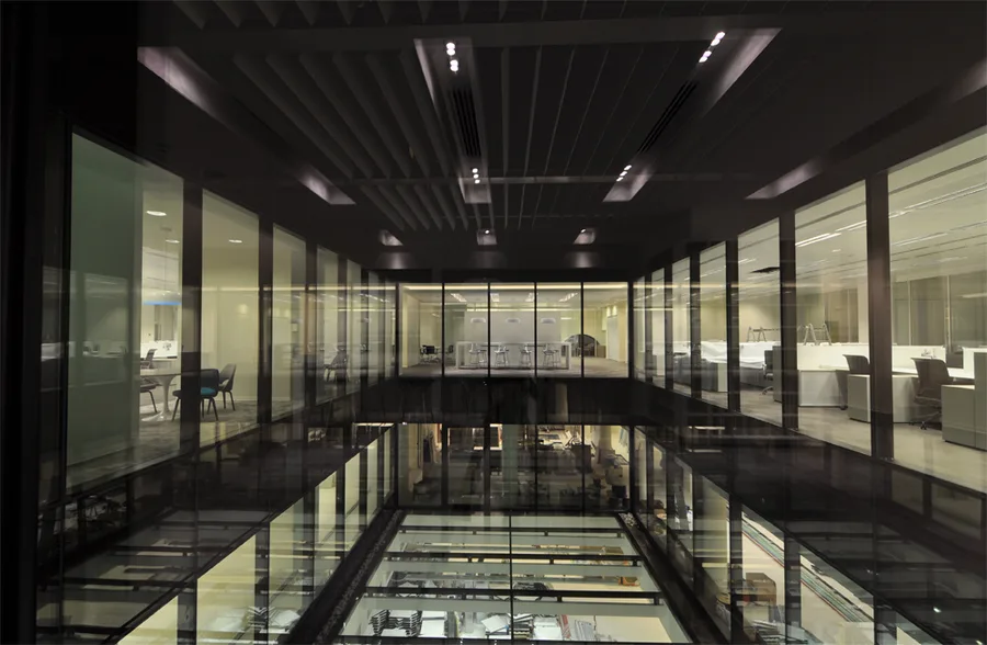 Level 2 meeting room interior with modern glass partitions inserted within the heritage brick structure