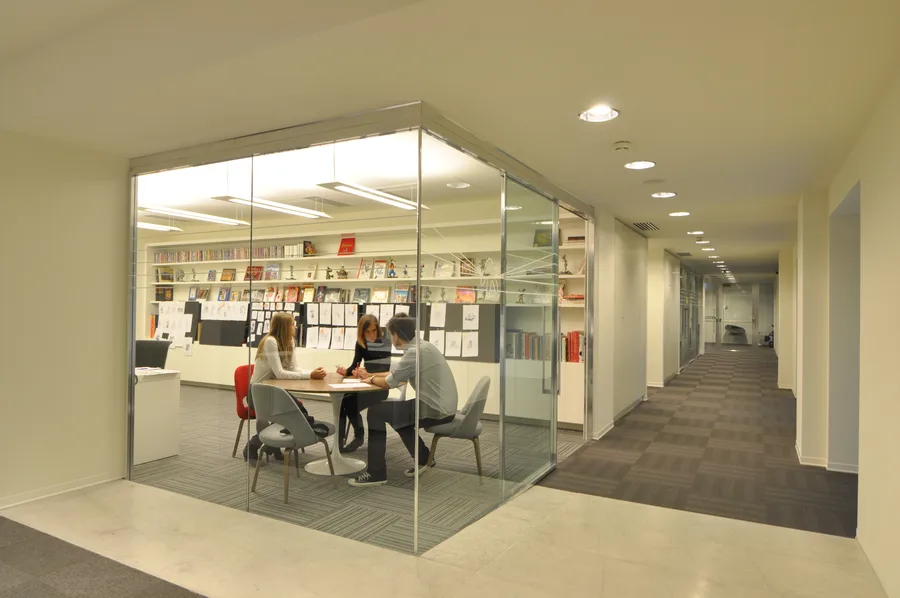 Creative studio with Disney character sketches pinned on walls, animation art books, and figurines on display shelves