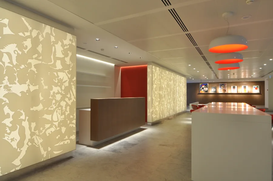 Bar close-up showing Artemide Skydro pendant material detail and the interplay of brushed metal, Corian panels, and Grey Oak surfaces
