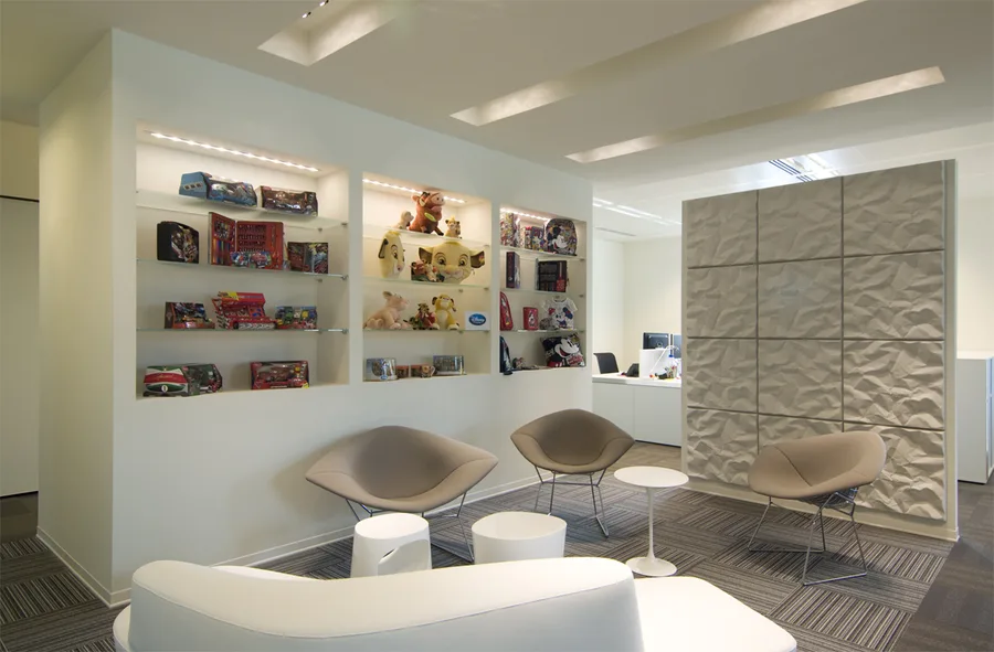 Interior: Level 2 breakout with 3D textured wall panel, symmetrical blue Artemide Skydro pendants, Bertoia stools, and warm white downlighting