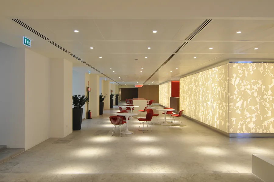 Full interior composition of the Disney headquarters showing the complete design vocabulary across multiple zones