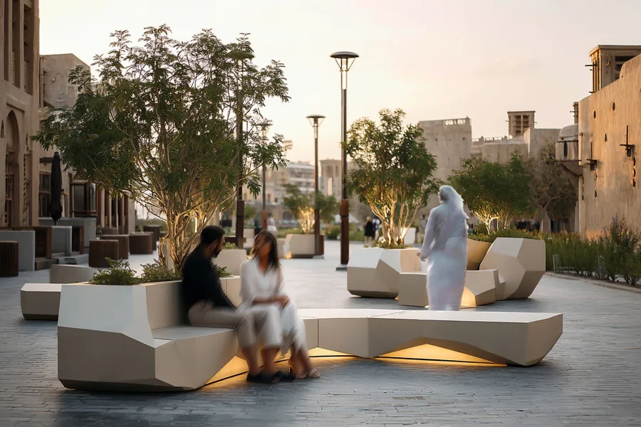 Historical zone dusk render showing UHPC bench cluster with integrated planter, seated figures, and traditional Dubai architecture backdrop