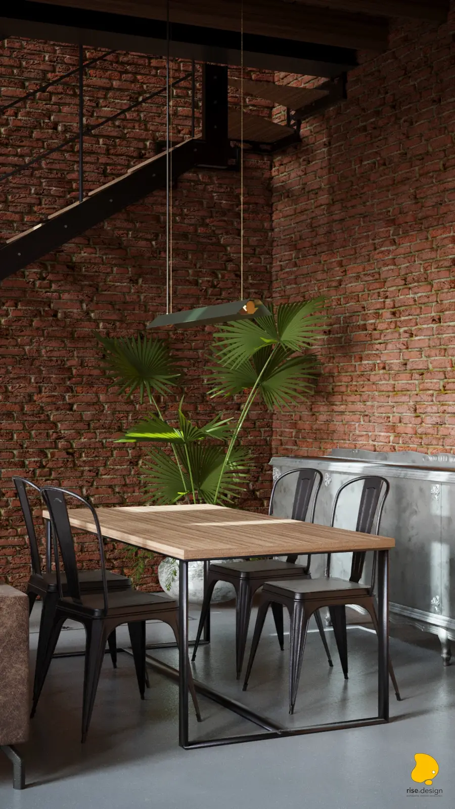 Dining area with oak-topped table, Tolix chairs, ornate silver baroque sideboard against brick wall, green industrial pendant, and fan palm