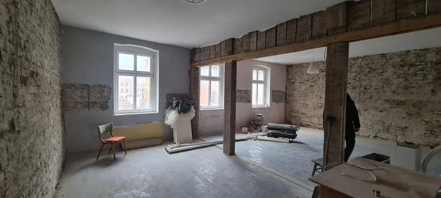 Interior: stripped interior shell during January 2023 survey showing exposed brickwork, removed plaster, and cleared floor plate for new layout