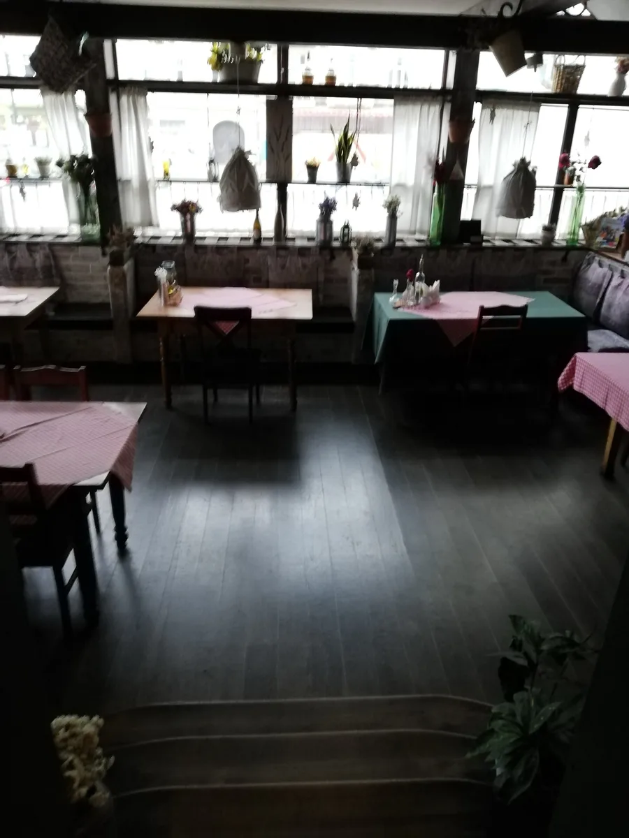 Ground floor with pink tablecloths and dated dining setup showing the Dolce Vita interior before the complete Orso Nero renovation