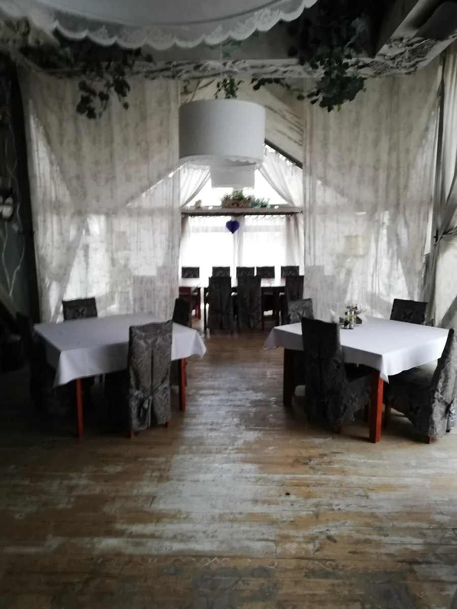 First floor with curtains hiding the triangular steel windows, old carpeting, and dated decor before the design transformation