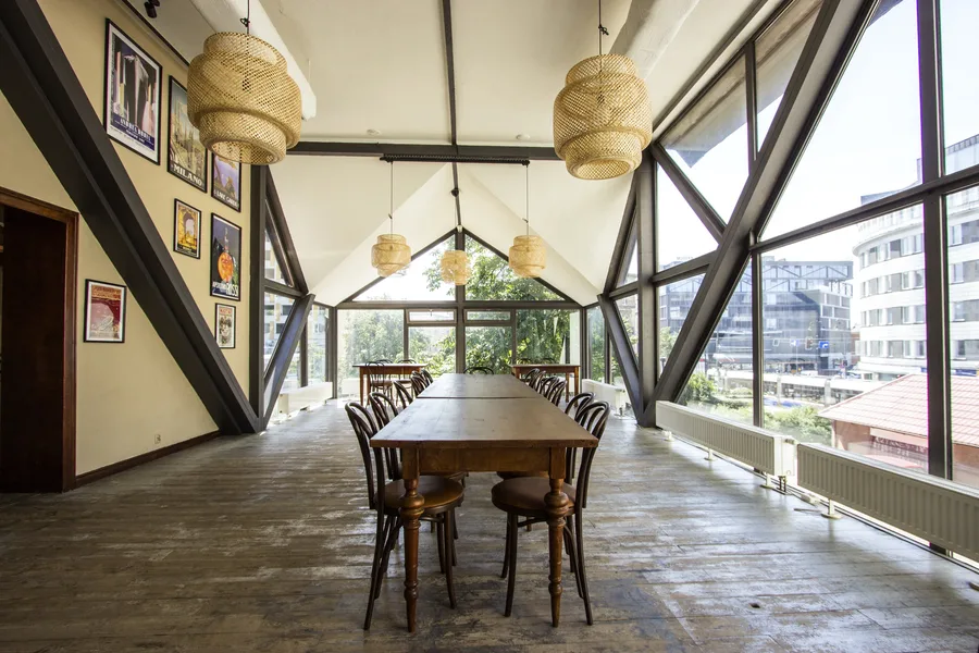 Staircase ascending between levels with wrought iron decorative balustrade, reclaimed timber wall panels, and pendant lighting along the climb