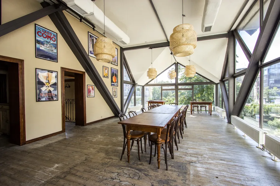 Sculptural microcement landing with organic curved steps connecting levels, reclaimed timber wall panels, and natural light from above