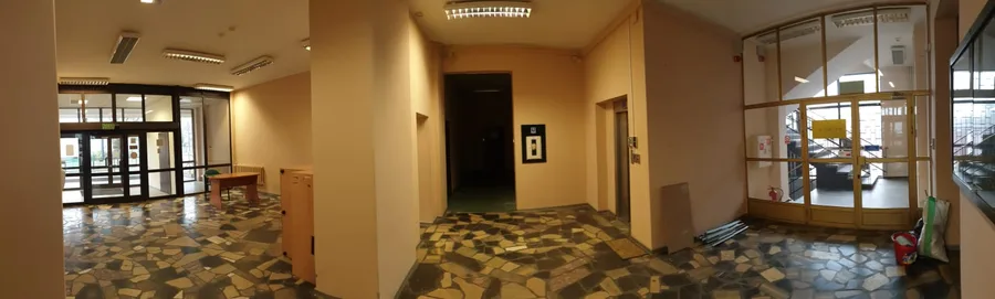 Documentary: ground floor lobby photograph showing the original 1970s terrazzo mosaic floor pattern, institutional corridor character, and heritage finishes preserved as an adaptive reuse design feature
