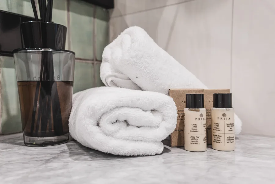Hotel amenities arranged on marble bathroom surface